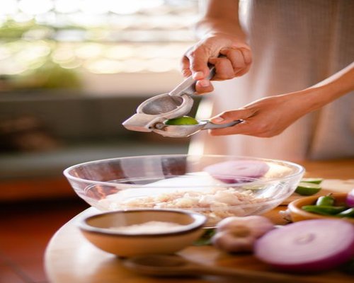 Fresh traditional ingredients including vegetables and lime on a rustic kitchen table in Mexico, representing healthy homemade eating